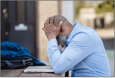 man with hands on head