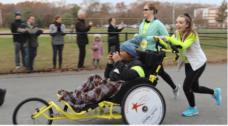 runner pushing wheelchair