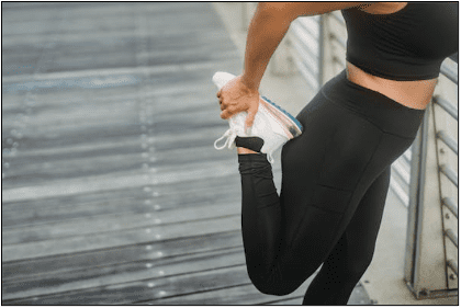woman stretching leg