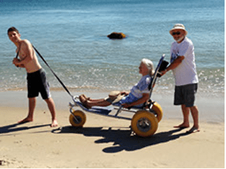 wheelchair pushed on beach
