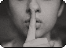 finger over mouth