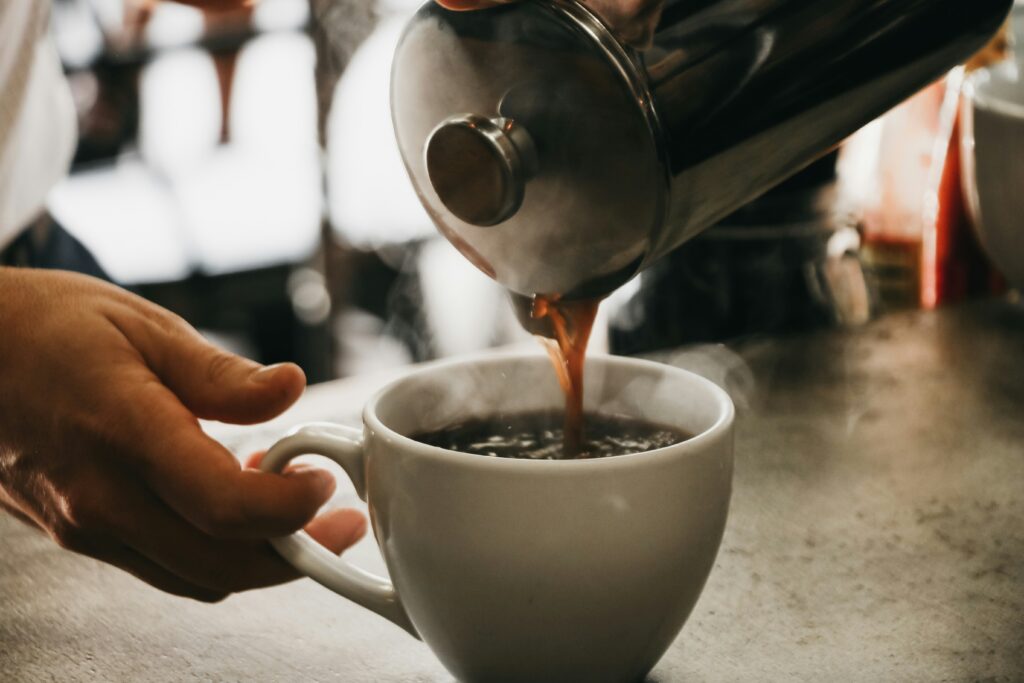 Close up of coffee being poured into a mug