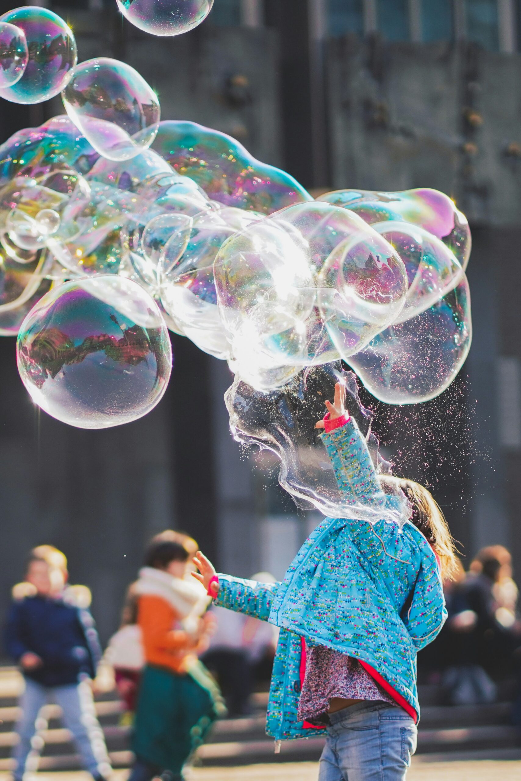 Child making large bubbles in the air
