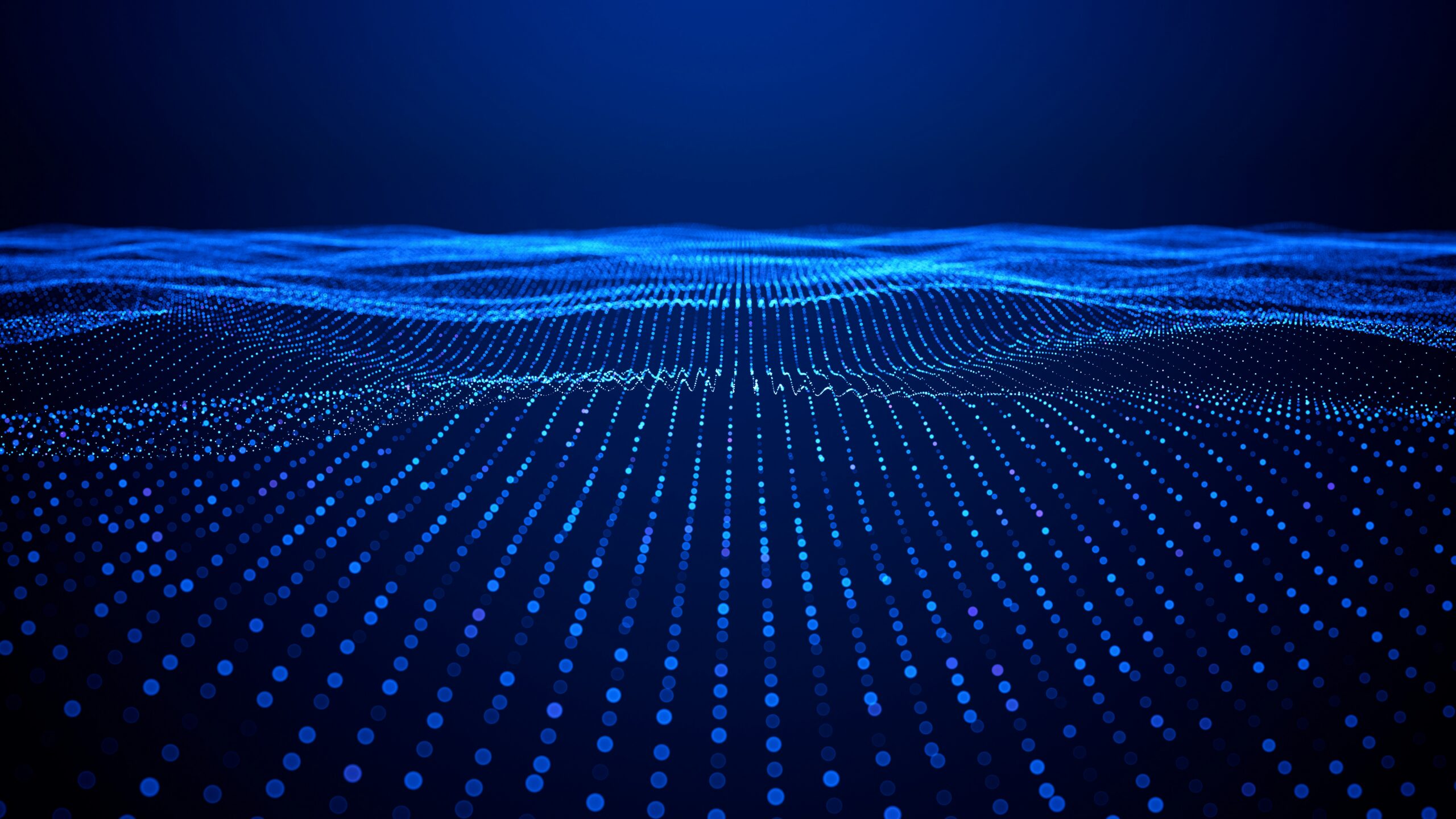 Abstract blue digital landscape made of glowing dots and lines forming wave-like patterns, representing flowing data or a connected network.