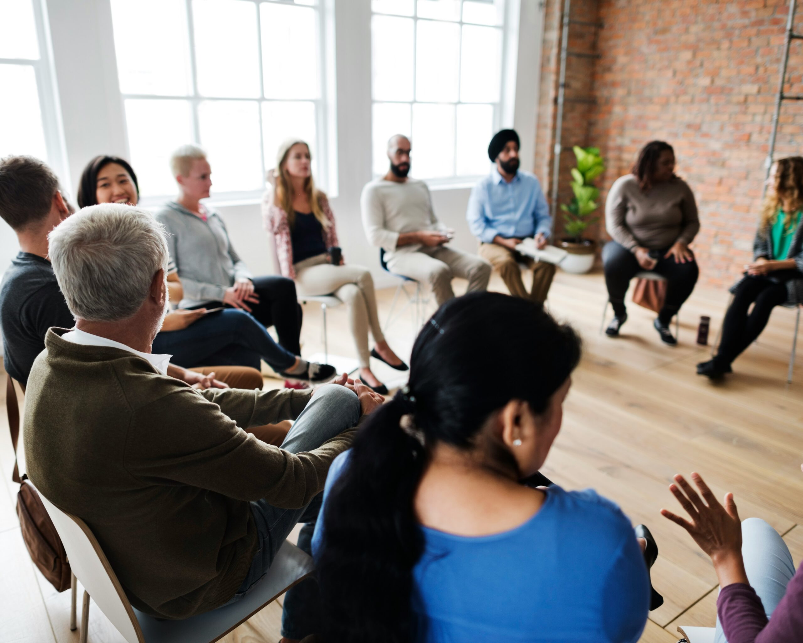 A group of people sitting in a circle having a discussion