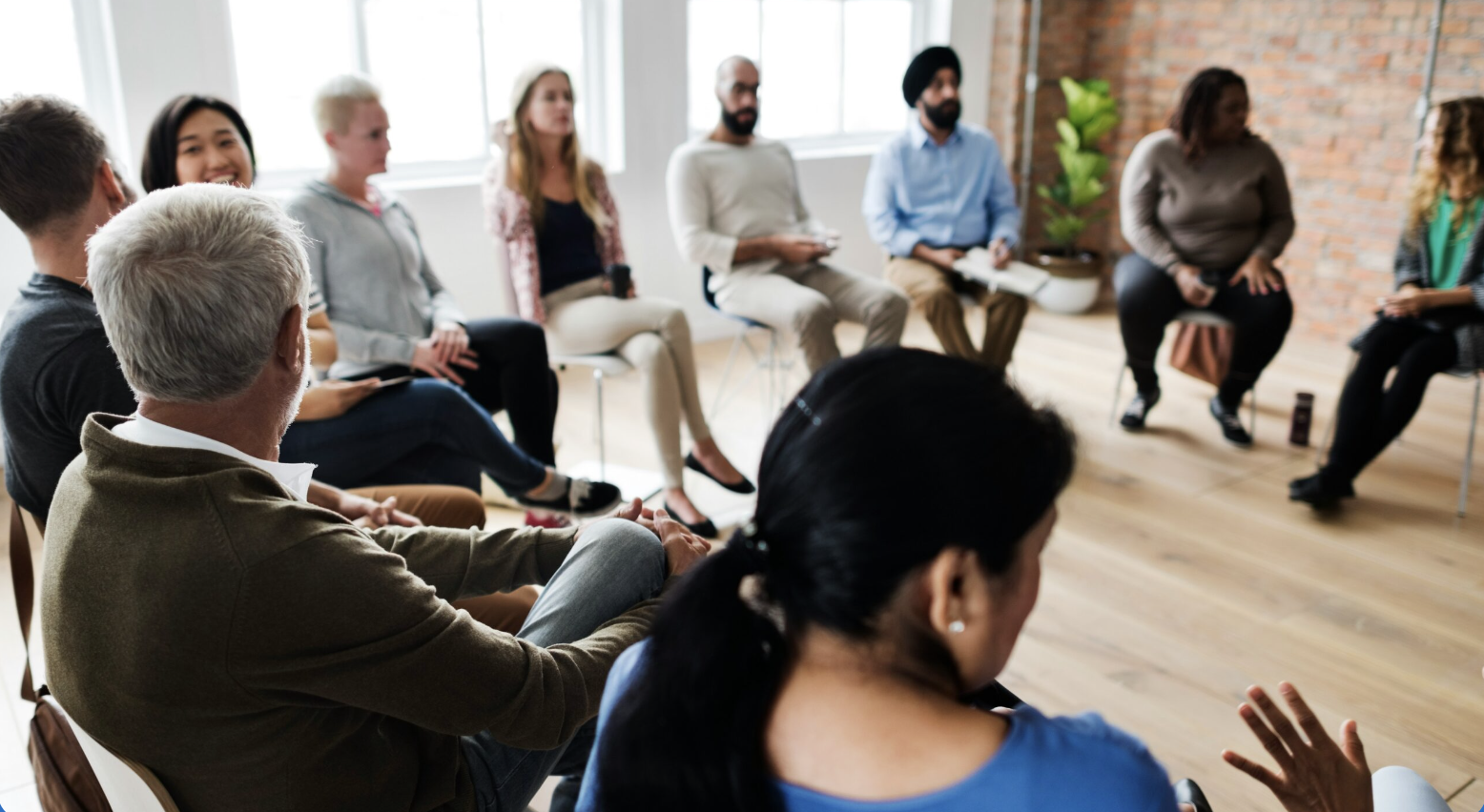 A group of people sitting in a circle having a discussion