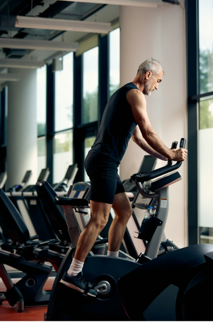 Older man on step machine at gym
